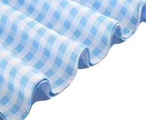 Detailed close-up of blue gingham fabric with ruffled wavy hem and precision stitching