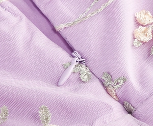 Détails de la fermeture éclair invisible et broderie florale sur robe en tulle