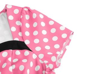 Detail of pink polka dot vintage dress showing neckline and black fabric patchwork