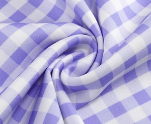 Detailed macro view of purple and white gingham pattern fabric with textured pleats