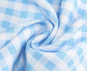 Macro shot of light blue and white gingham fabric showing detailed woven texture and drape