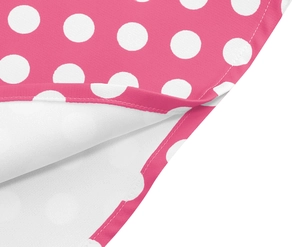 Detailed view of pink polka dot dress hem with high-quality stitching and fabric texture