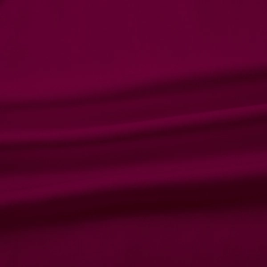 Detailed macro view of high-end wine red fabric with fine textile texture and soft drape