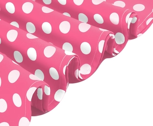 Detail of pink polka dot dress showing high-quality fabric texture and fine stitching