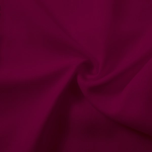 Close-up of burgundy bamboo linen fabric showing smooth drape and fine matte texture