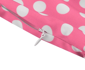 Detail of pink polka dot dress showing high-quality white invisible zipper and fabric texture