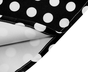 Détail de la couture fine et de l'ourlet de qualité sur la robe rétro à pois