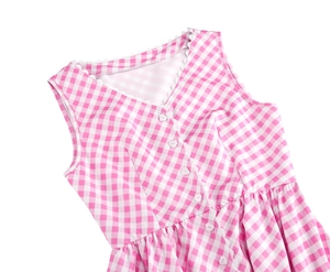 Detail of pink plaid dress featuring V-neckline with lace trim and heart shaped buttons