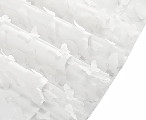 Close-up of white mesh fabric featuring 3D butterfly appliques on an elegant summer dress