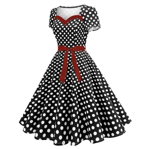 Detail of vintage polka dot dress featuring a red sweetheart neckline and belted waist