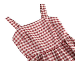 Detail of red gingham sundress showing square neckline and shirred waist texture
