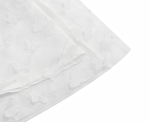 Detail of white mesh dress featuring 3D butterfly appliques and delicate sequins