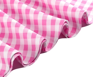 Detailed close-up of pink and white checkered fabric with elegant pleated ruffle hem texture