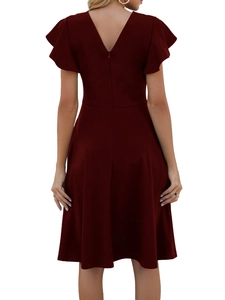 Detail view of the hidden back zipper and elegant V-neckline on the burgundy dress