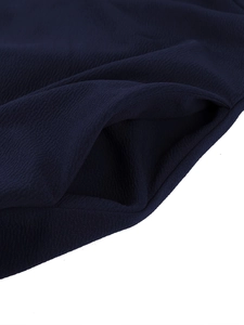 Close-up of textured dark blue evening gown fabric showing side pocket detail