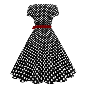Detail of vintage polka dot dress featuring a retro A-line skirt and contrast red belt