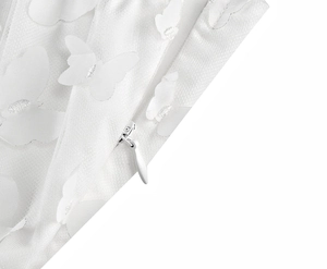 Detail of 3D butterfly appliques on white mesh fabric with a hidden zipper closure