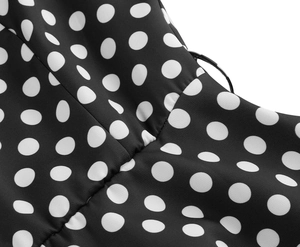 Close-up of black and white polka dot fabric texture with precise stitching details