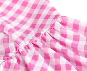 Detailed view of pink gingham fabric featuring ruffled and gathered sewing craftsmanship