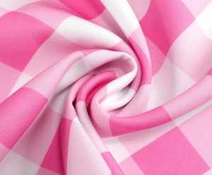 Vue macro du tissu vichy rose et blanc avec un drapé souple et des détails tissés