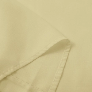 Macro detail of beige plain weave fabric showing fine stitching and quality texture