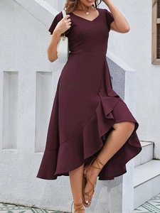 Detail view of the elegant deep burgundy V-neck dress with asymmetric ruffled fishtail hem