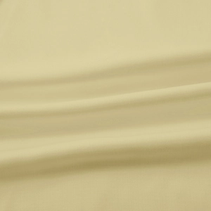 Close-up of beige linen fabric texture and soft pleats on a women's short-sleeved blouse