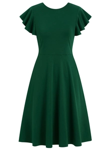 Detail of dark green dress showing soft knit texture, crew neck and ruffled flutter sleeves