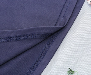 Detail view of precise stitching on navy blue fabric with colorful floral embroidery