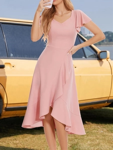 Detail of elegant pink V-neck dress featuring ruffle sleeves and asymmetric hemline