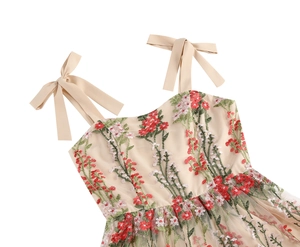 Detail of floral embroidery on beige mesh dress with bow shoulder straps in vintage style