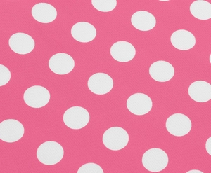 Gros plan sur le tissu à pois roses pour une robe ajustée au style rétro