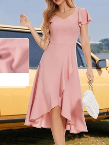 Detail of pink chiffon dress featuring elegant ruffle sleeves and premium fabric texture