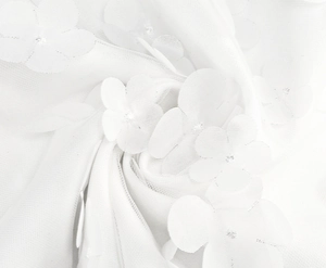 Detail of white 3D floral lace mesh fabric with intricate embroidery for elegant gowns