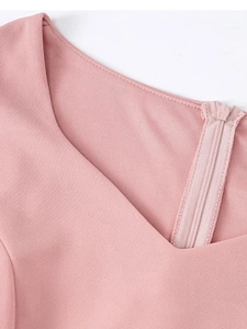 Detail of V-neckline on pink elegant evening dress with invisible zipper closure
