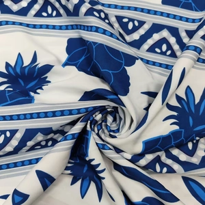Detail of blue and white tropical pineapple print fabric with soft pleats and texture