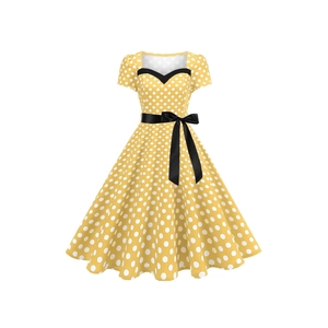Vintage 1950s yellow polka dot dress with Audrey Hepburn style and a black bow belt