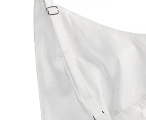 Macro detail of adjustable satin shoulder strap with a silver metal buckle on white dress