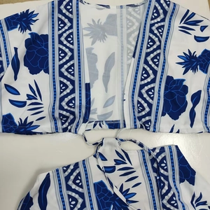 Detail showing blue and white floral pineapple print on a matching two-piece summer outfit