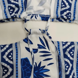 Detail of blue and white bohemian floral print fabric with adjustable drawstring ties