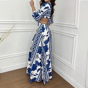 Detail of blue floral maxi dress featuring a side waist cutout and batwing sleeves