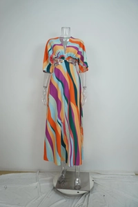 Detailed view of deep V-neck and waist cutout design with colorful abstract wave pattern