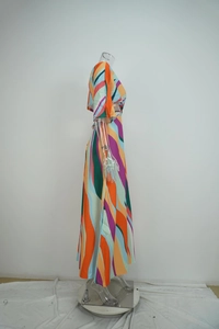 Detail of colorful wave geometric print dress featuring a side high slit and V-neckline