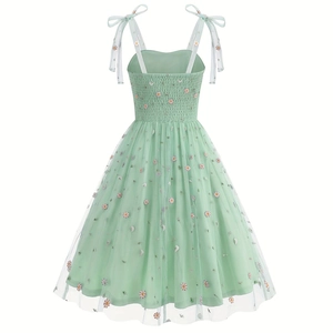 Detail of mint green floral embroidery on tulle dress with adjustable shoulder bows