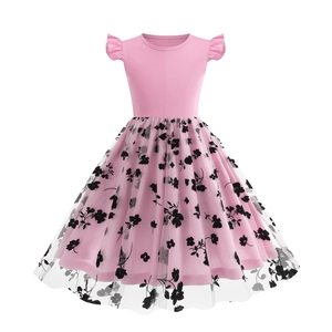 Detail view of pink girl's dress with ruffled sleeves and black floral mesh overlay