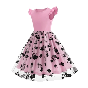 Detail of pink ruffled sleeves and black floral mesh overlay on a girl's dress