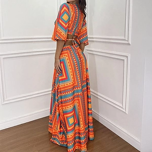 Women's bohemian two-piece set featuring geometric print crop top and high waist maxi skirt