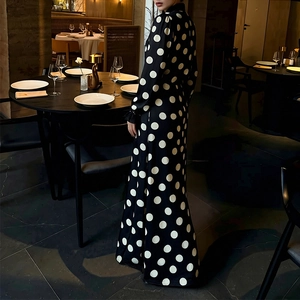Elegant vintage polka dot maxi dress with V-neckline and puff sleeves in upscale restaurant