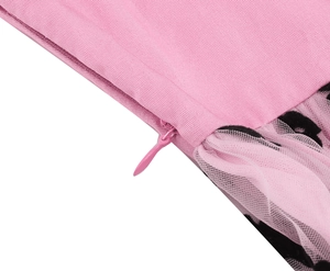 Detailed macro view of the pink girl's dress featuring an invisible zipper and mesh fabric