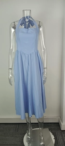 Detail of an elegant light blue halter midi dress with a backless bow design.